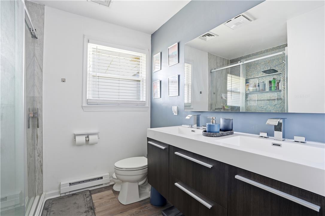 2918 Keystone Street Bethlehem, PA 18020 - Photo 20 of 54 Clean lines and modern fixtures define this bathroom, featuring a dual vanity and a spacious glass-enclosed shower.