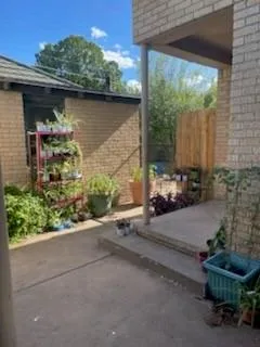 a backyard of a house with a yard and outdoor seating