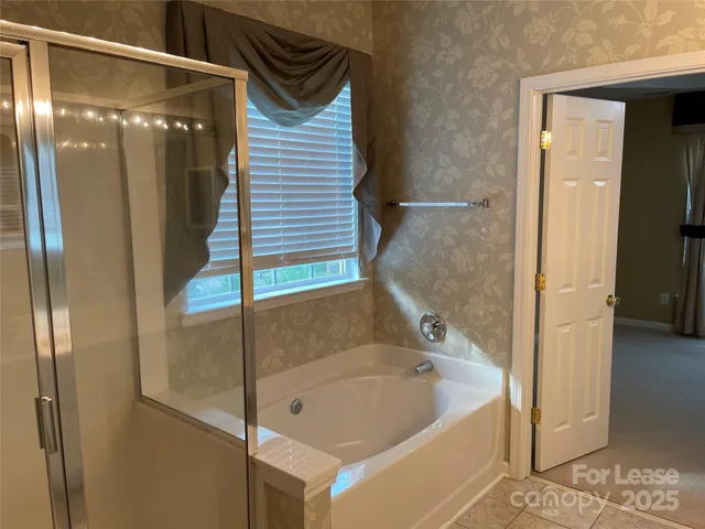 a bathroom with a bathtub and a shower