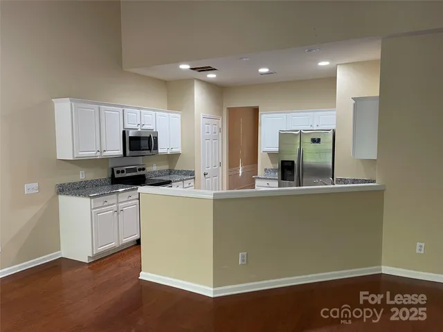 a kitchen with sink a microwave and cabinets
