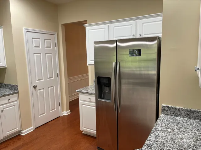 a kitchen with metallic refrigerator freezer and a dishwasher