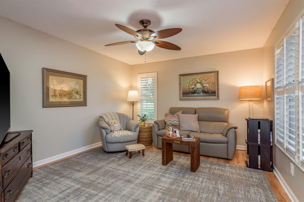 3184 Brunswick Circle Palm Harbor, FL 34684 - Photo 18 of 57 a living room with furniture and a ceiling fan