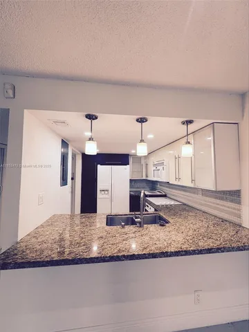 a view of a kitchen counter space and wooden floor