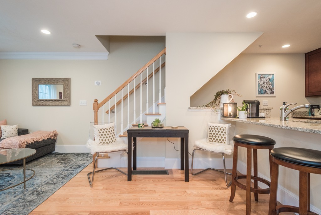 143 Broad Street, Unit 20 Hudson, MA 01749 - Photo 16 of 30 a living room with furniture and a wooden floor