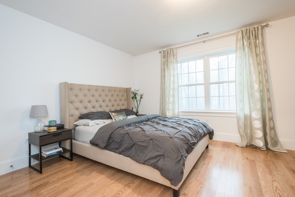 143 Broad Street, Unit 20 Hudson, MA 01749 - Photo 17 of 30 a bedroom with a bed and a window