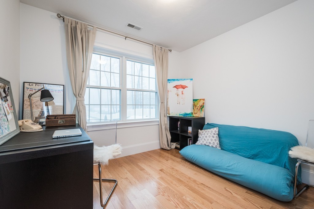 143 Broad Street, Unit 20 Hudson, MA 01749 - Photo 23 of 30 a living room with furniture and a window