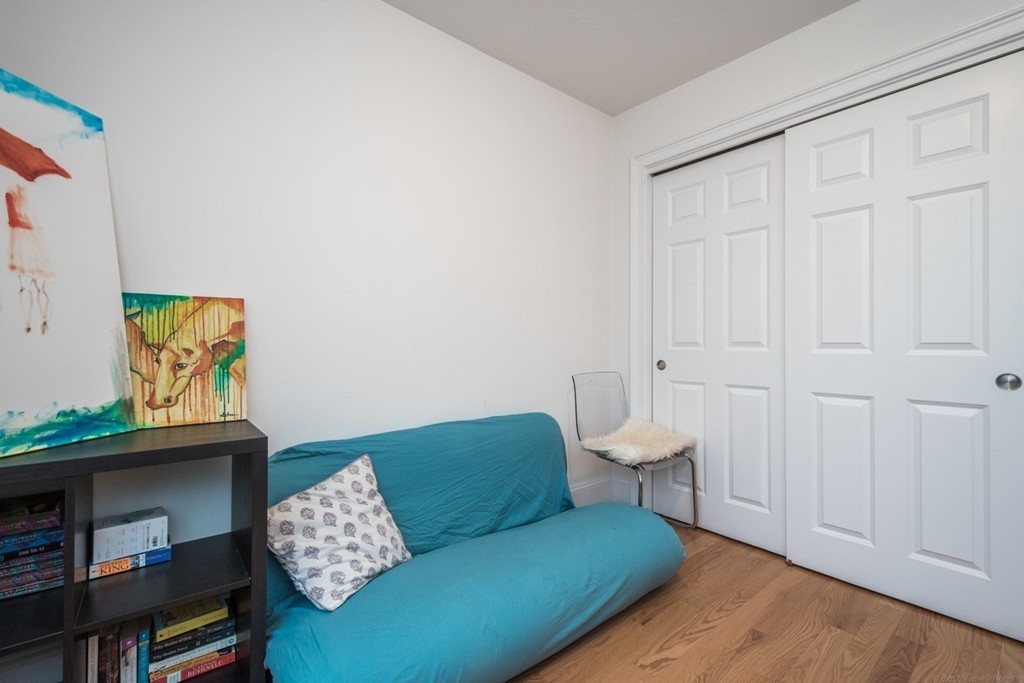143 Broad Street, Unit 20 Hudson, MA 01749 - Photo 24 of 30 a living room with furniture and a book shelf