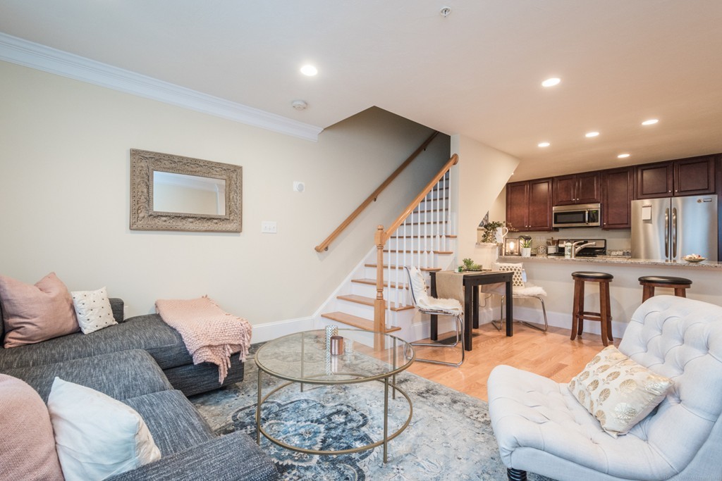 143 Broad Street, Unit 20 Hudson, MA 01749 - Photo 6 of 30 a living room with furniture kitchen view and a wooden floor