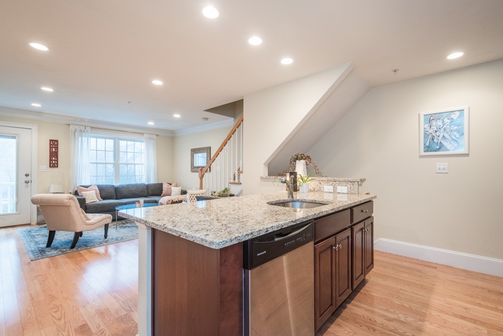 143 Broad Street, Unit 20 Hudson, MA 01749 - Photo 8 of 30 a living room with granite countertop furniture and wooden floor