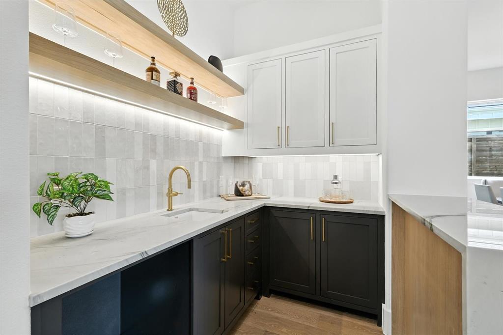 7618 Roper Street Dallas, TX 75209 - Photo 17 of 35 a kitchen with a sink a potted plant and cabinets