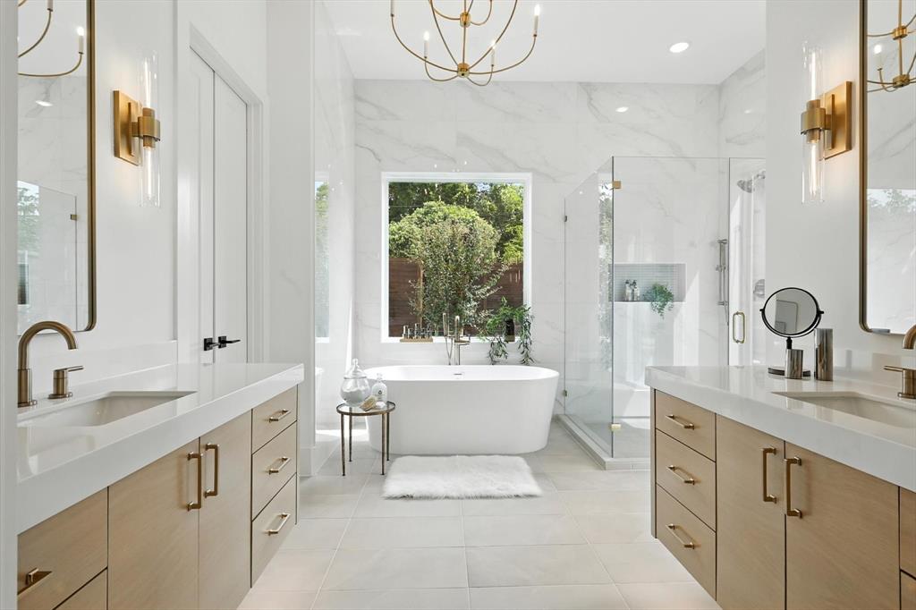 7618 Roper Street Dallas, TX 75209 - Photo 19 of 35 a bathroom with a double vanity sink a mirror and a bathtub
