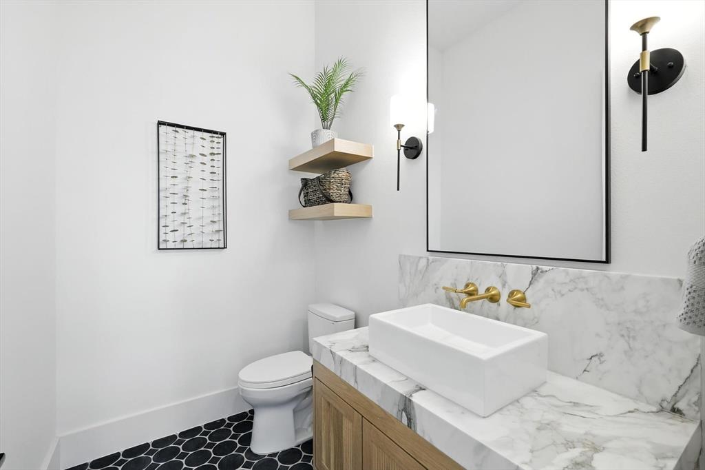 7618 Roper Street Dallas, TX 75209 - Photo 22 of 35 a bathroom with a sink mirror vanity and toilet