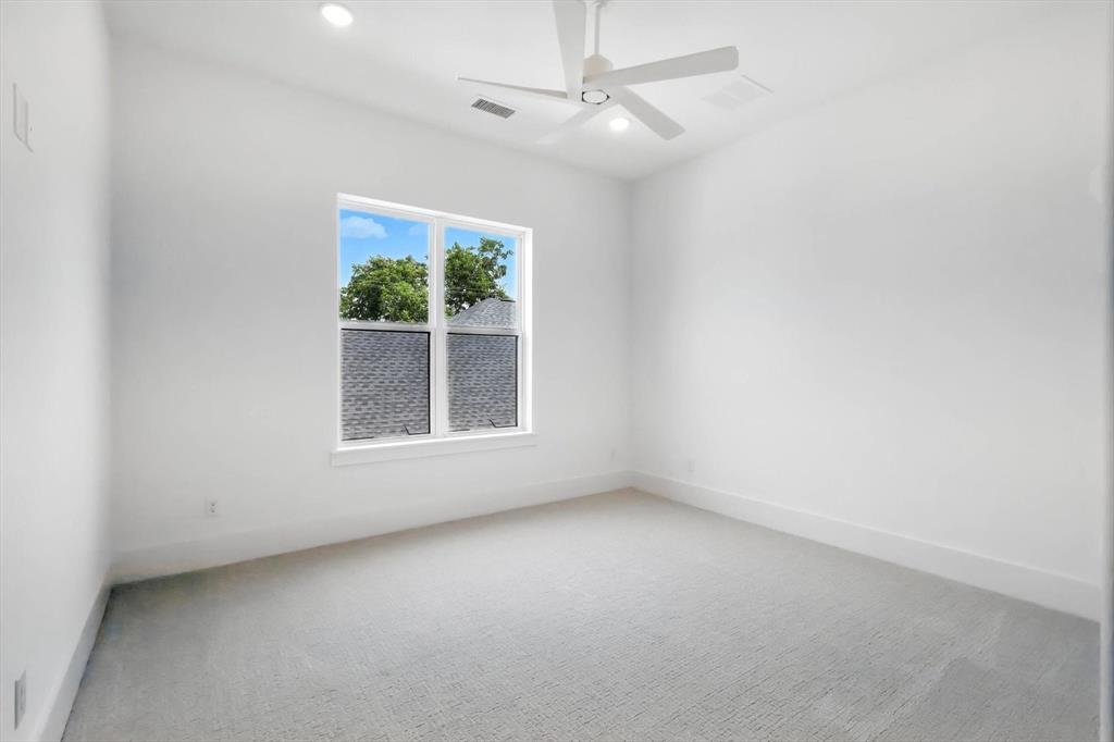 7618 Roper Street Dallas, TX 75209 - Photo 23 of 35 an empty room with a window and a ceiling fan