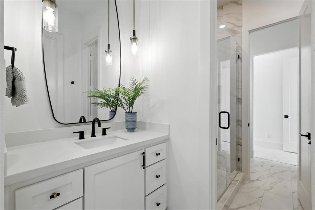 7618 Roper Street Dallas, TX 75209 - Photo 24 of 35 a bathroom with double sink and a mirror