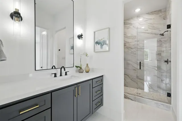 a bathroom with a double vanity sink mirror and shower