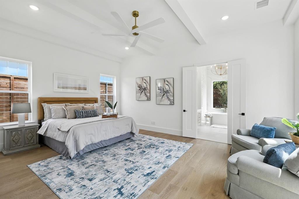 7618 Roper Street Dallas, TX 75209 - Photo 31 of 35 a spacious bedroom with a bed a couch and potted plant