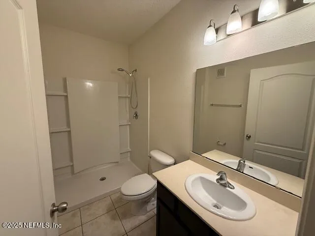 a bathroom with a sink toilet a mirror and shower
