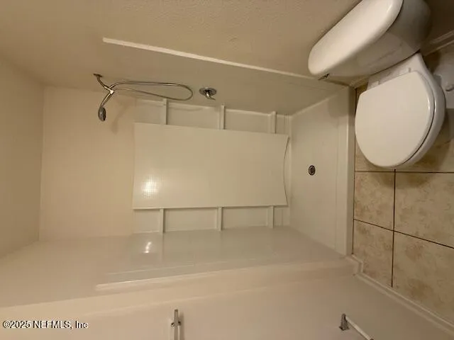 a bathroom with a shower and mirror