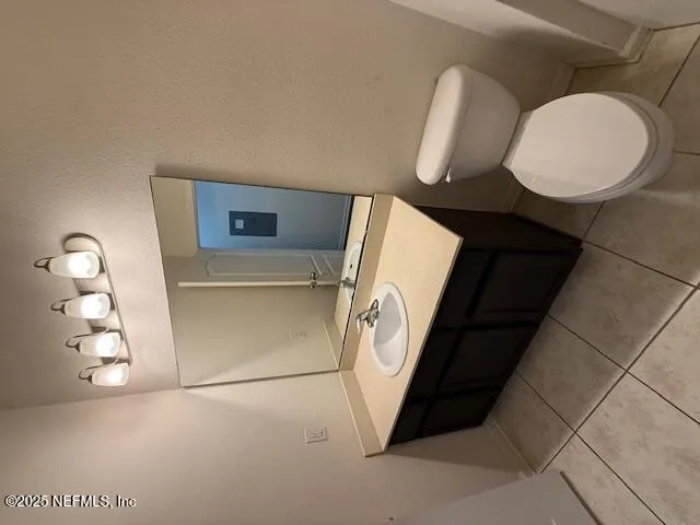 a bathroom with a toilet and a mirror