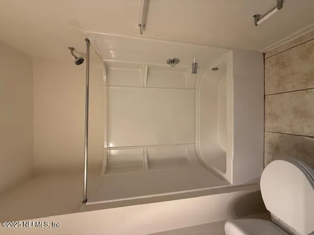 a bathroom with a glass shower door