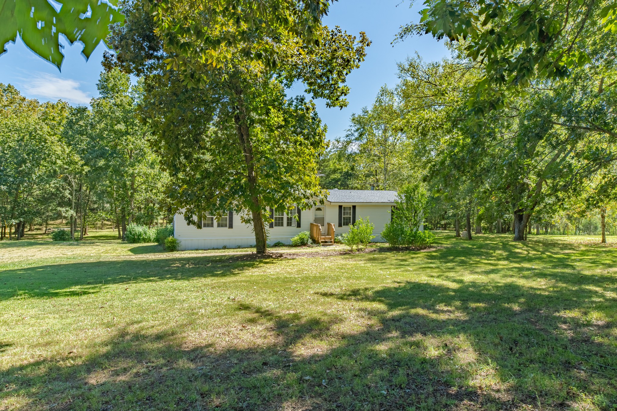 5085 Flat Creek Road Spring Hill, TN 37174 - Photo 13 of 17 a view of a house with a big yard and large trees