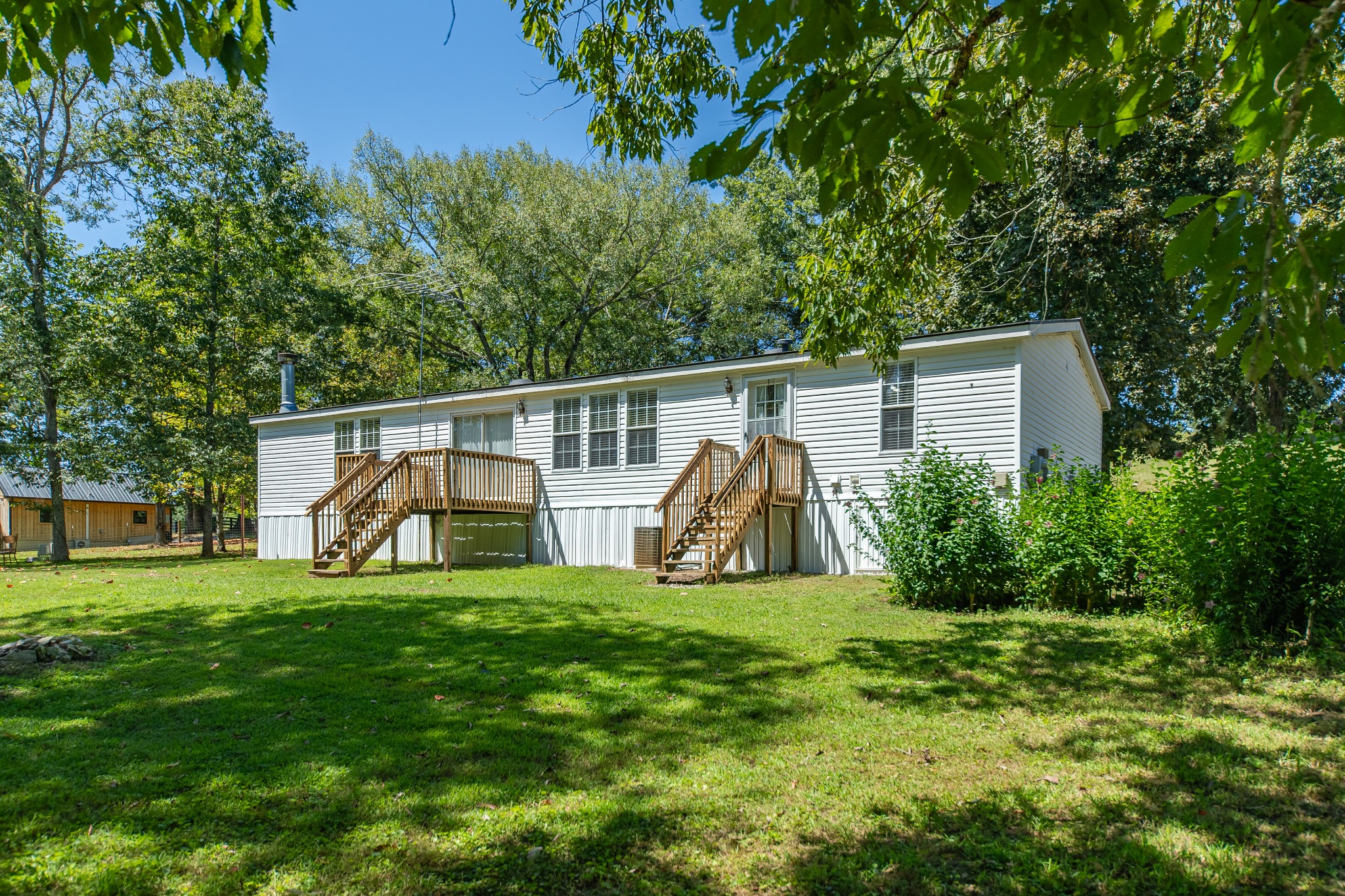 5085 Flat Creek Road Spring Hill, TN 37174 - Photo 14 of 17 a view of a backyard with white house and wooden fence