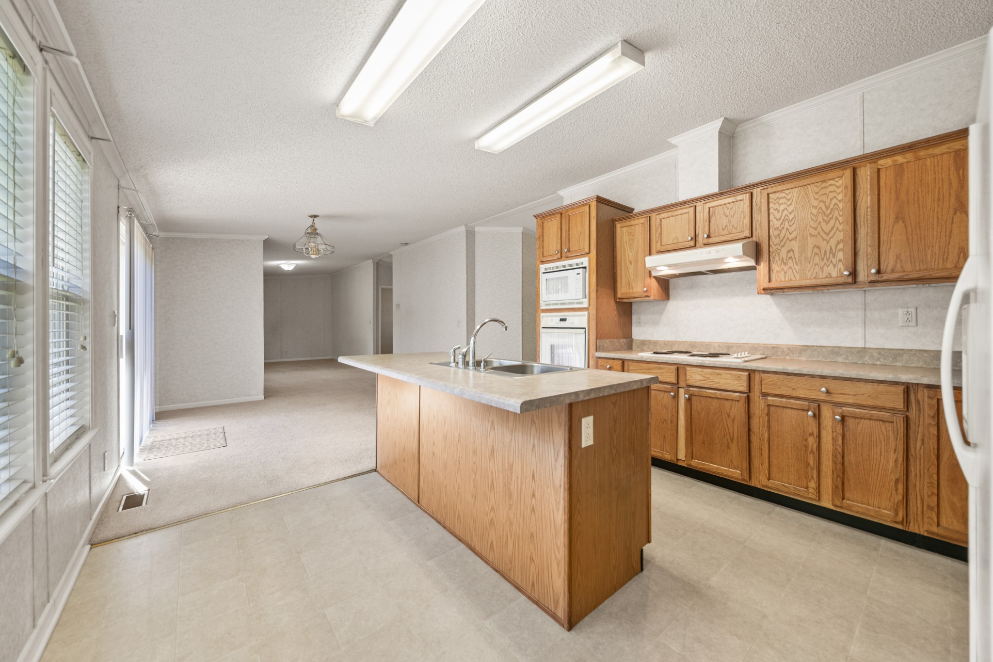 5085 Flat Creek Road Spring Hill, TN 37174 - Photo 15 of 17 a kitchen with granite countertop a sink stove top oven and cabinets