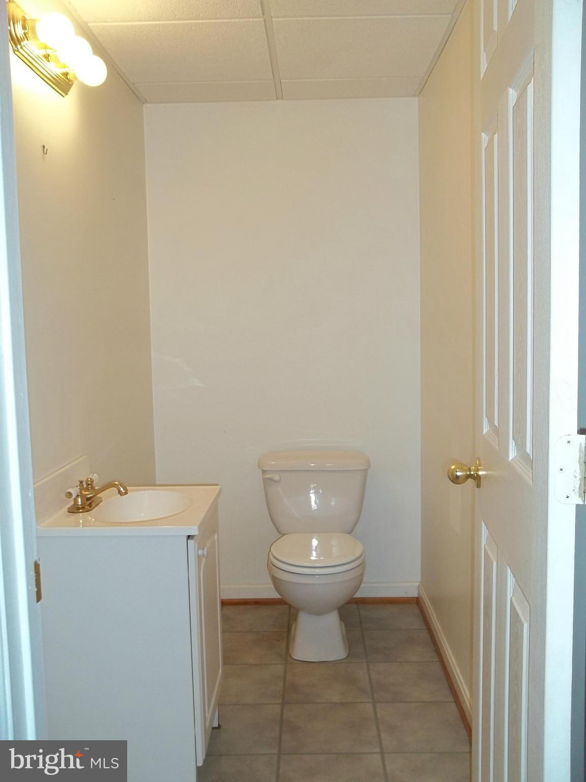 6624 Ridge Road Eldersburg, MD 21784 - Photo 19 of 20 a bathroom with a toilet sink and mirror
