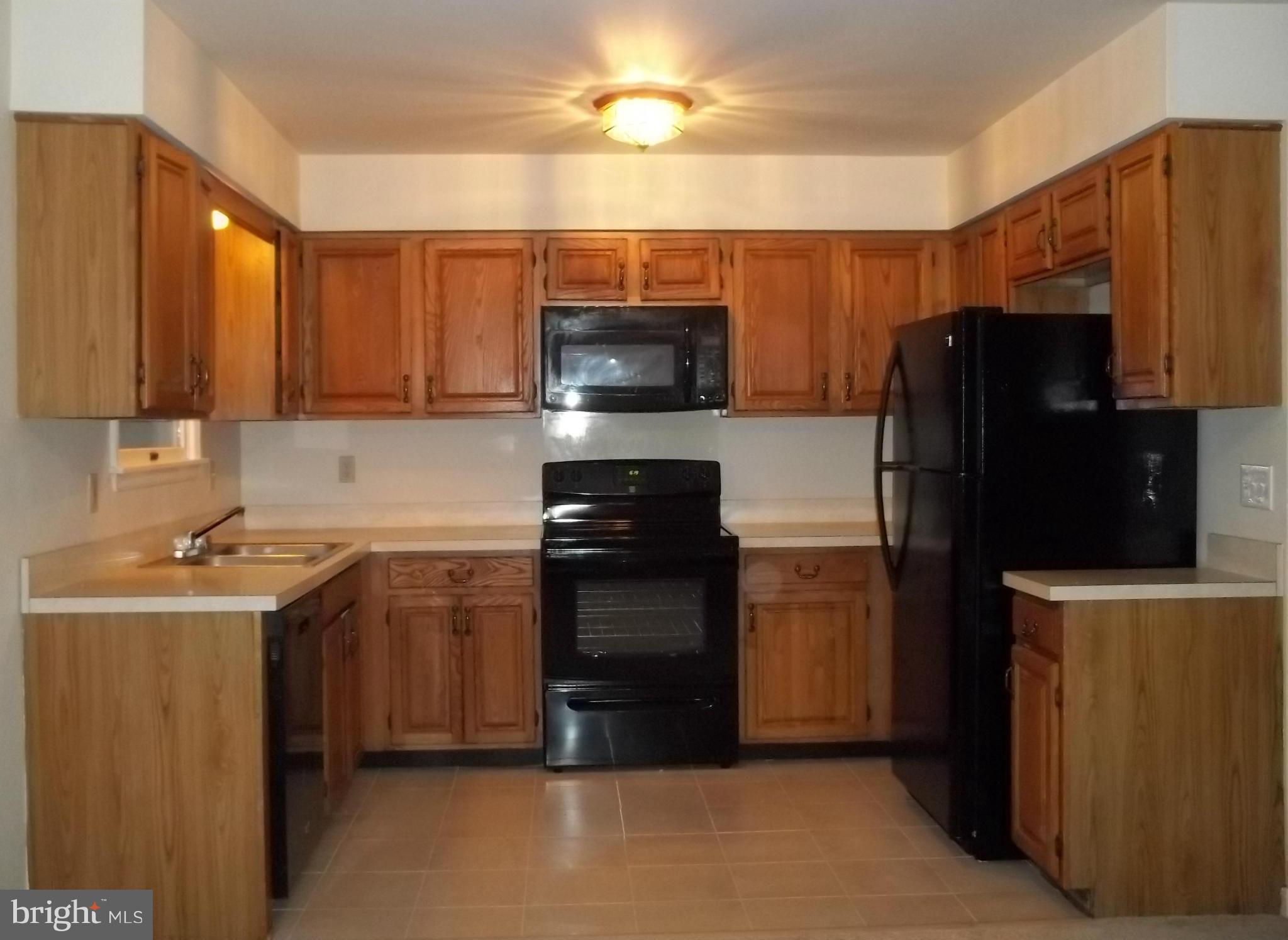 6624 Ridge Road Eldersburg, MD 21784 - Photo 3 of 20 a kitchen with a refrigerator stove and microwave