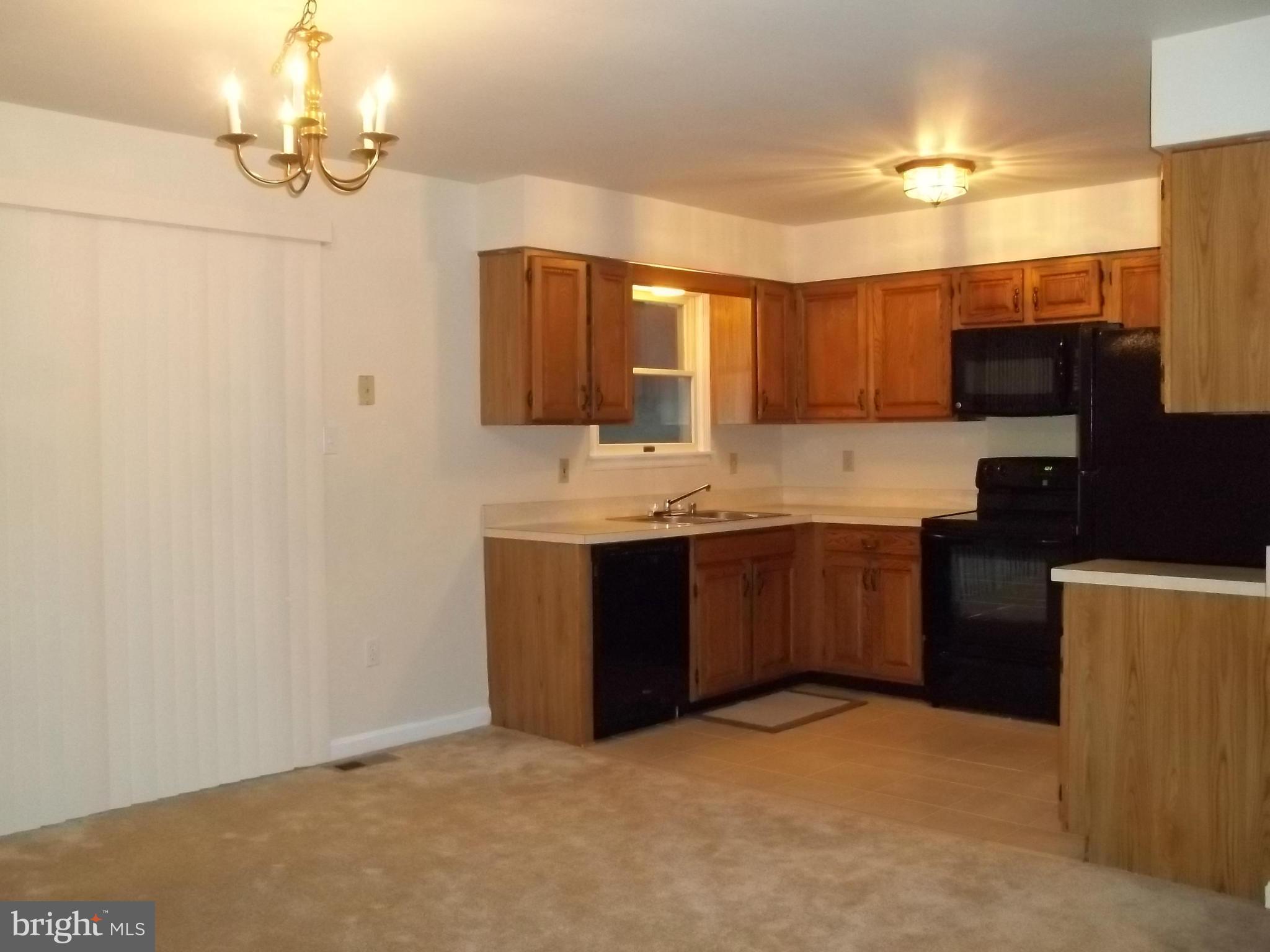 6624 Ridge Road Eldersburg, MD 21784 - Photo 4 of 20 a kitchen with a refrigerator sink and cabinets