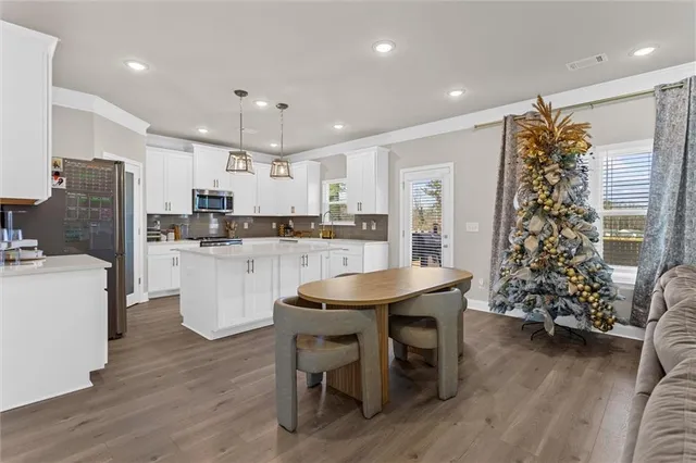 a kitchen with a table and chairs
