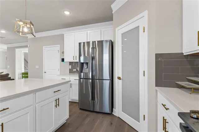 a kitchen with a refrigerator a sink and cabinets