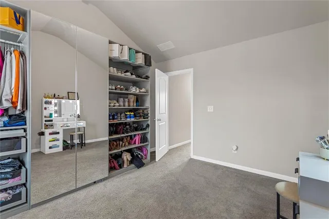 a bedroom with a bed and a mirror