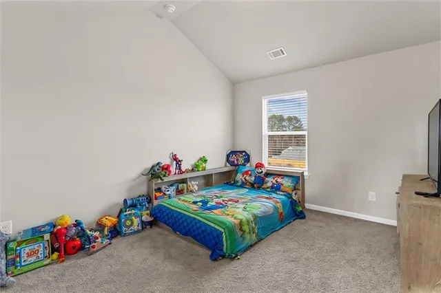 a bedroom with baby bed and window