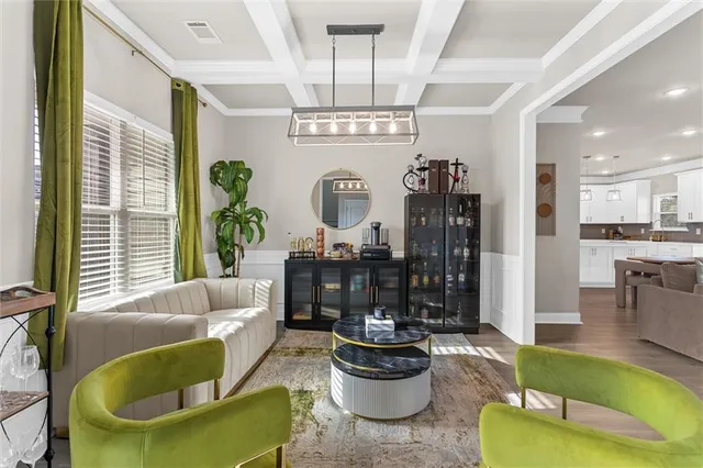 a living room with furniture and a chandelier
