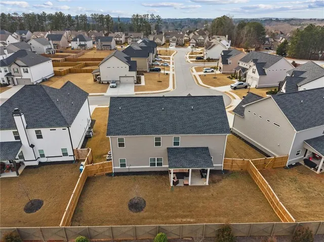 an aerial view of residential houses with outdoor space