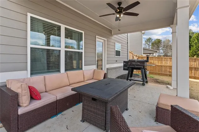 a view of a house with backyard and deck