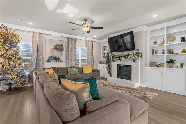 a living room with furniture fireplace and flat screen tv
