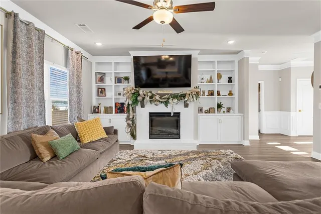 a living room with furniture flat screen tv and a fireplace