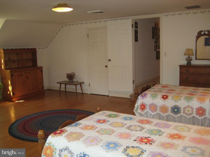 110 Glenwood Road Haddonfield, NJ 08033 - Photo 13 of 17 a bedroom with a bed and wooden floor