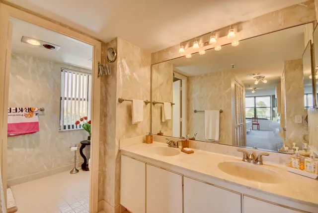 a bathroom with a sink vanity tub and shower