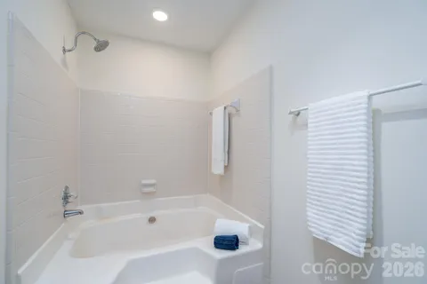 a bathroom with a bathtub and shower