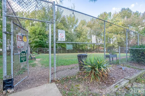 a view of a chair and table in backyard of the house