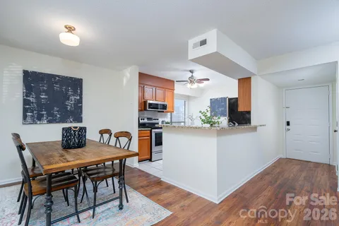 a view of a dining room with furniture and wooden floor