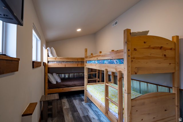 2029 West Tollgate Road Coalville, UT 84017 - Photo 14 of 36 Sloped ceiling room featuring two wooden bunk beds, recessed lighting, wood-finish flooring, and two windows with wood sills