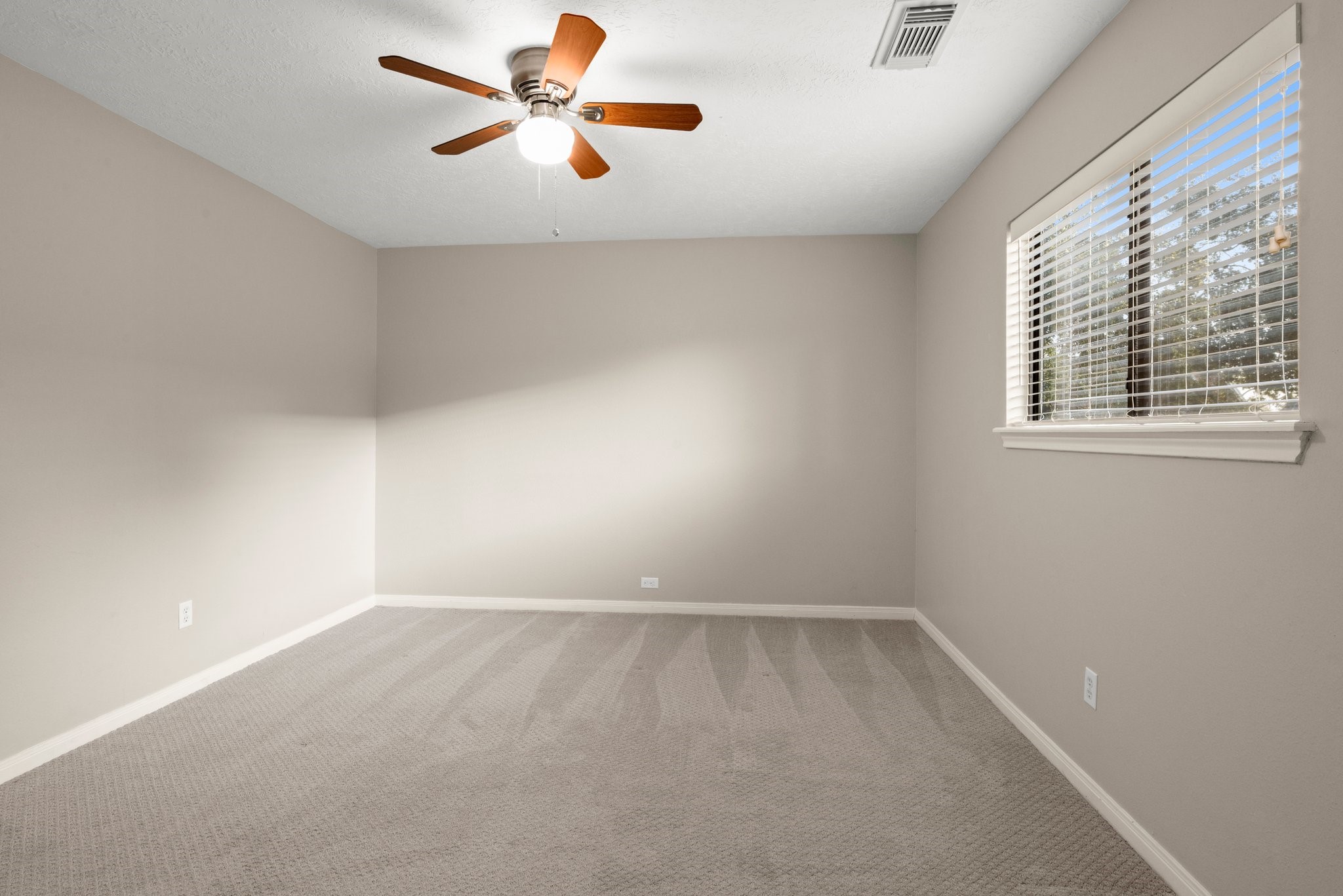 8222 Redchurch Drive Spring, TX 77379 - Photo 29 of 36 an empty room with windows and fan