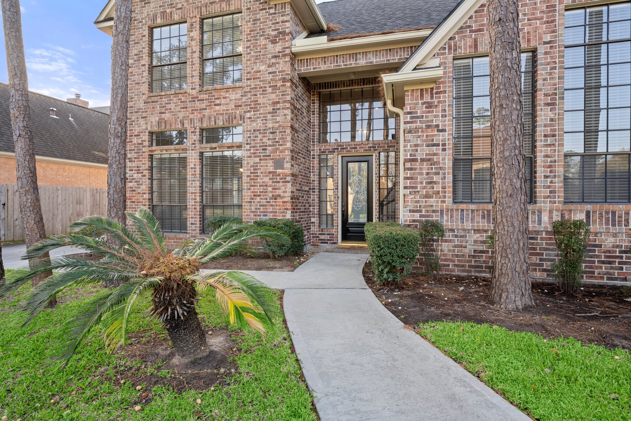 8222 Redchurch Drive Spring, TX 77379 - Photo 4 of 36 a view of a brick house with a yard and plants