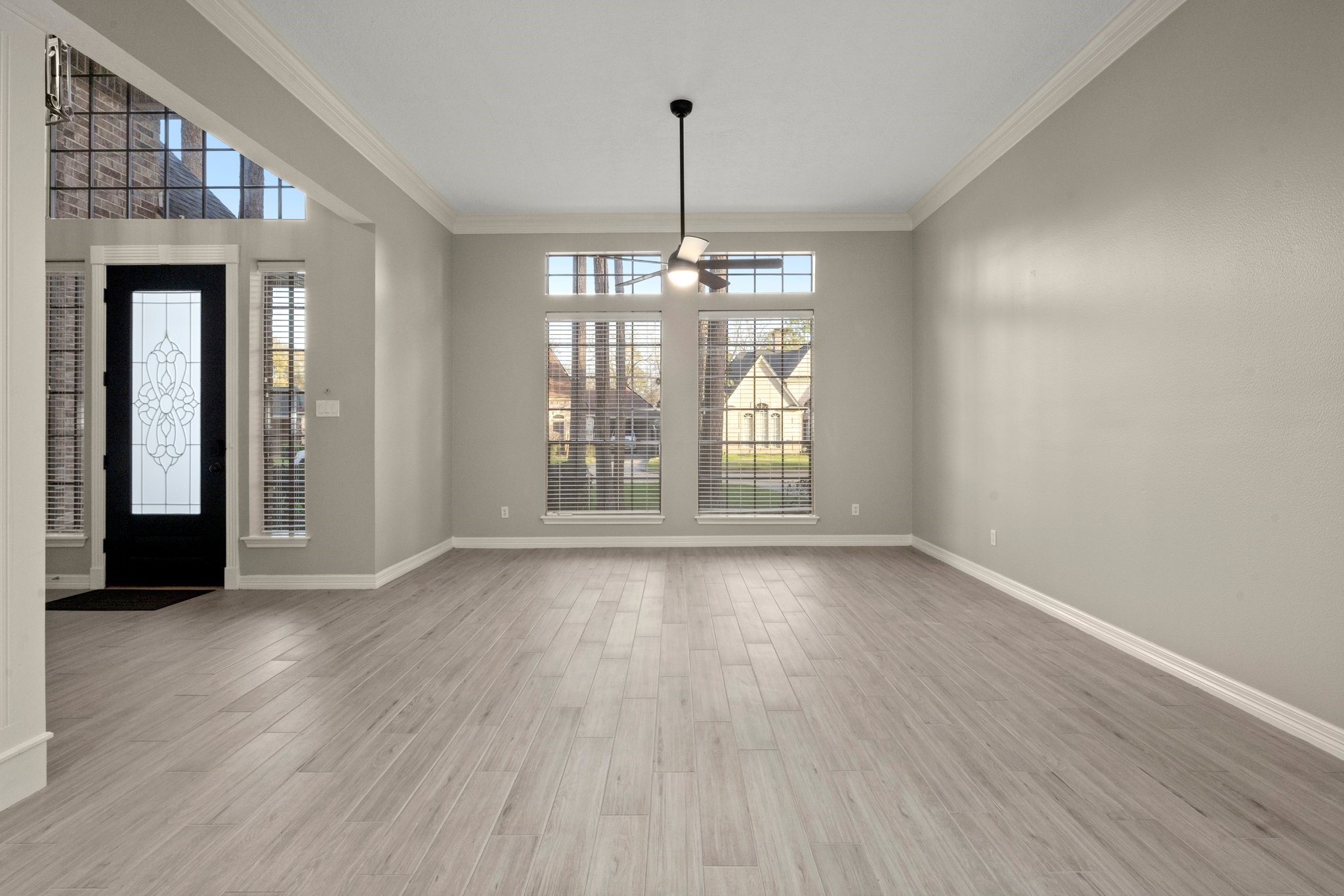 8222 Redchurch Drive Spring, TX 77379 - Photo 9 of 36 a view of an empty room with wooden floor and a window