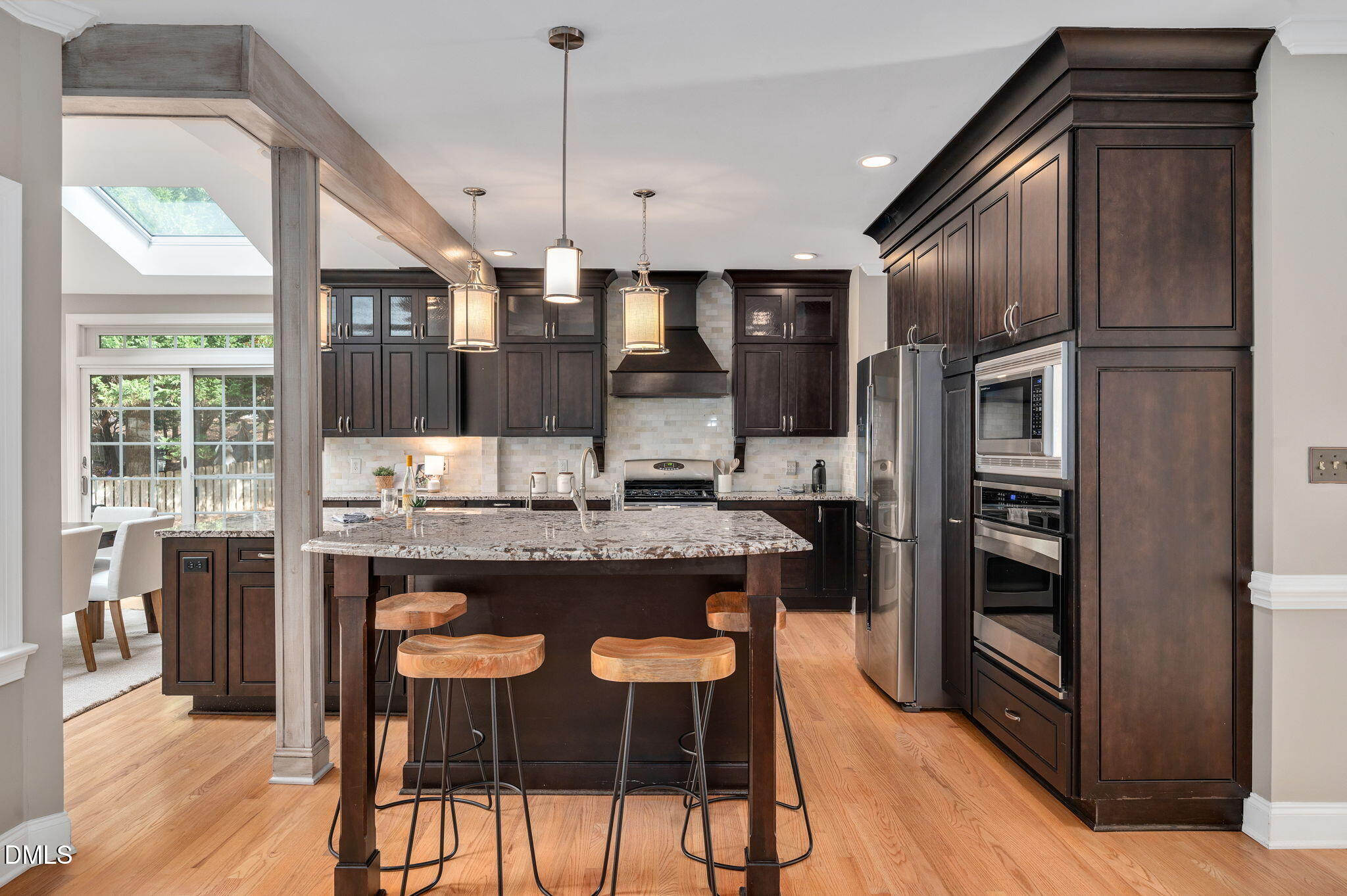 8325 Stryker Court Raleigh, NC 27615 - Photo 11 of 53 a kitchen with stainless steel appliances granite countertop a refrigerator a stove and a wooden floors