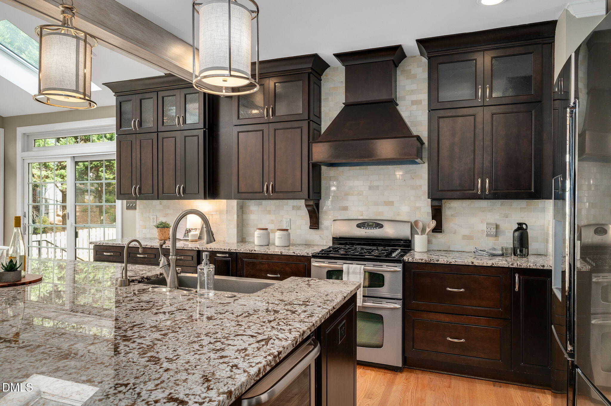 8325 Stryker Court Raleigh, NC 27615 - Photo 12 of 53 a kitchen with stainless steel appliances granite countertop a sink stove and refrigerator